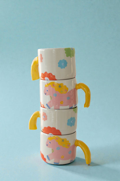 ceramic mug with a pony design and pony tail handle