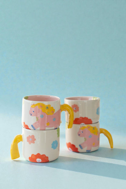 ceramic mug with a pony design and pony tail handle