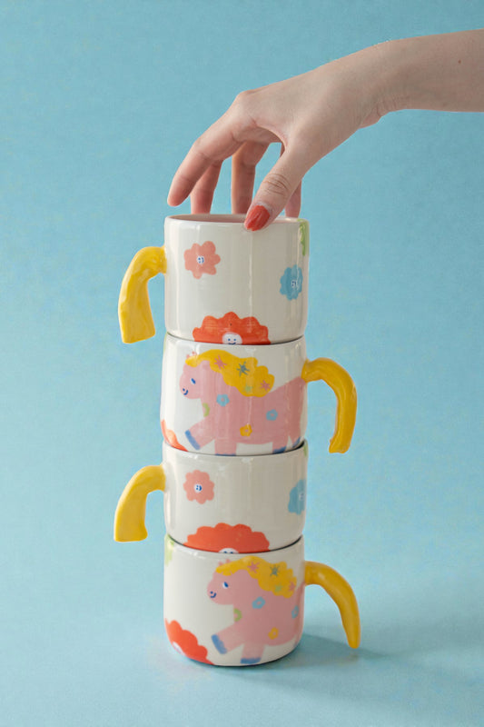 ceramic mug with a pony design and pony tail handle