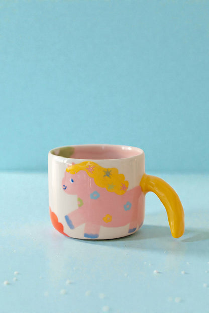 ceramic mug with a pony design and pony tail handle