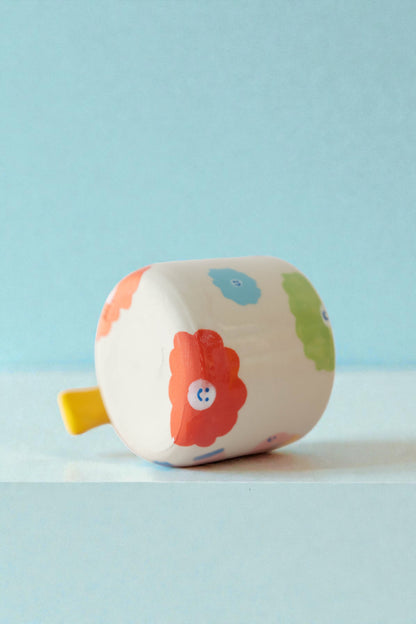 ceramic mug with a pony design and pony tail handle