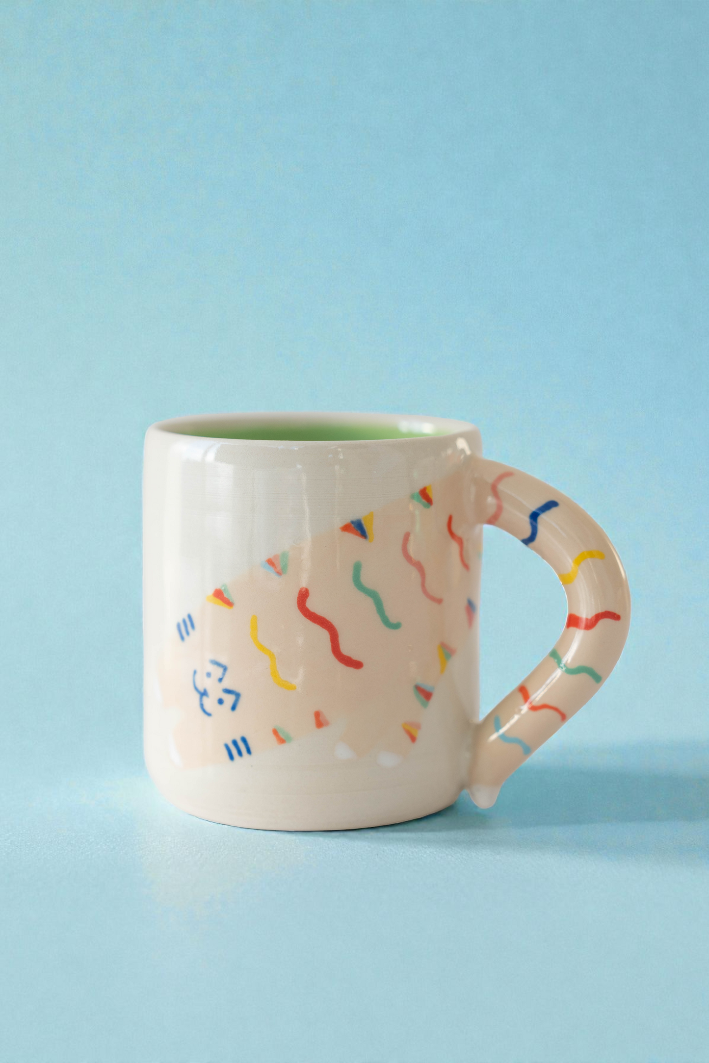Mug with colorful designs on a light blue background