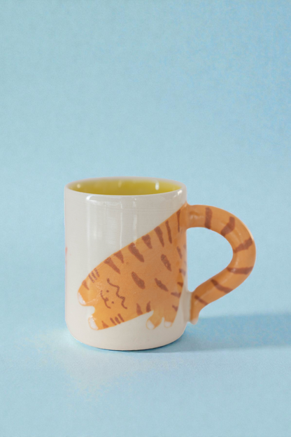 Mug with a cat design on a light blue background